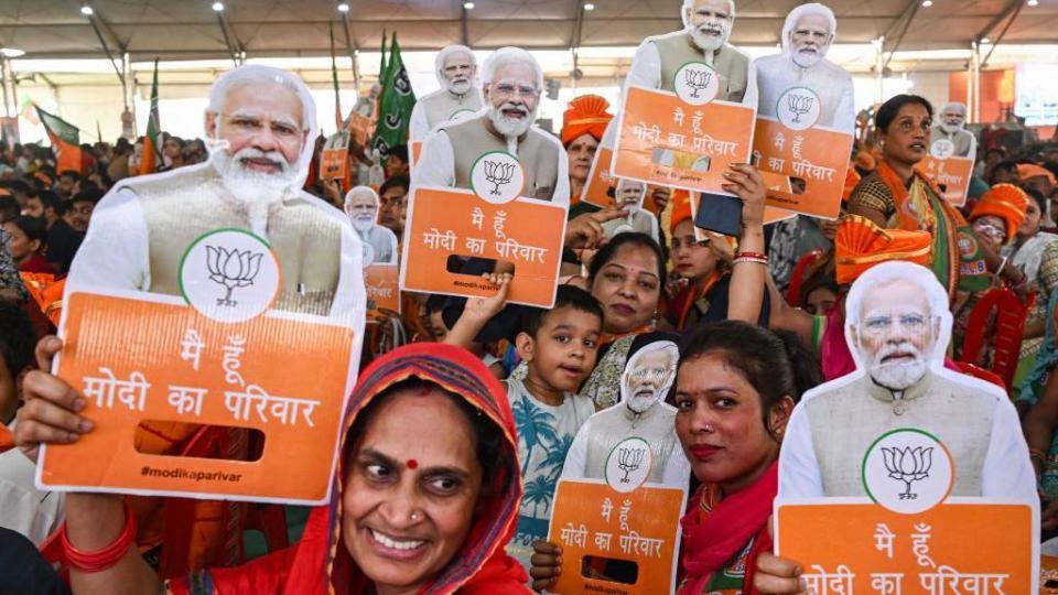 Supporters of the Bharatiya Janata Party (BJP) hold the image of Indian Prime Minister Narendra Modi during an election campaign in New Delhi on May 18, 2024, ahead of the fifth phase of polling for the country's ongoing general election.  (Photo by Arun SANKAR/AFP) (Photo by ARUN SANKAR/AFP via Getty Images)