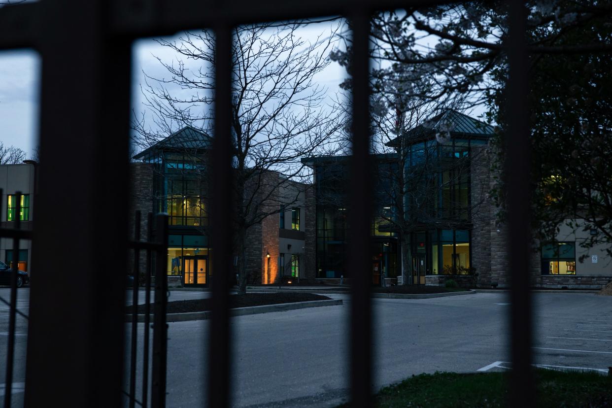 Glass school building covered by black fence