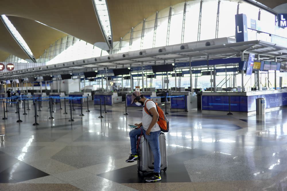 A man wearing a face mask is pictured at the Kuala Lumpur International Airport in Sepang March 18, 2020. In a statement, Health director-general Tan Sri Dr Noor Hisham Abdullah said more than 50 per cent of the country has reported the spread of Variant of Concerns’ (VoC) in the community. — Picture by Shafwan Zaidon
