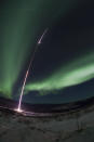 rocket flies through the aurora borealis after lifting off from the University of Poker Flat Research Range near Fairbanks, Alaska.