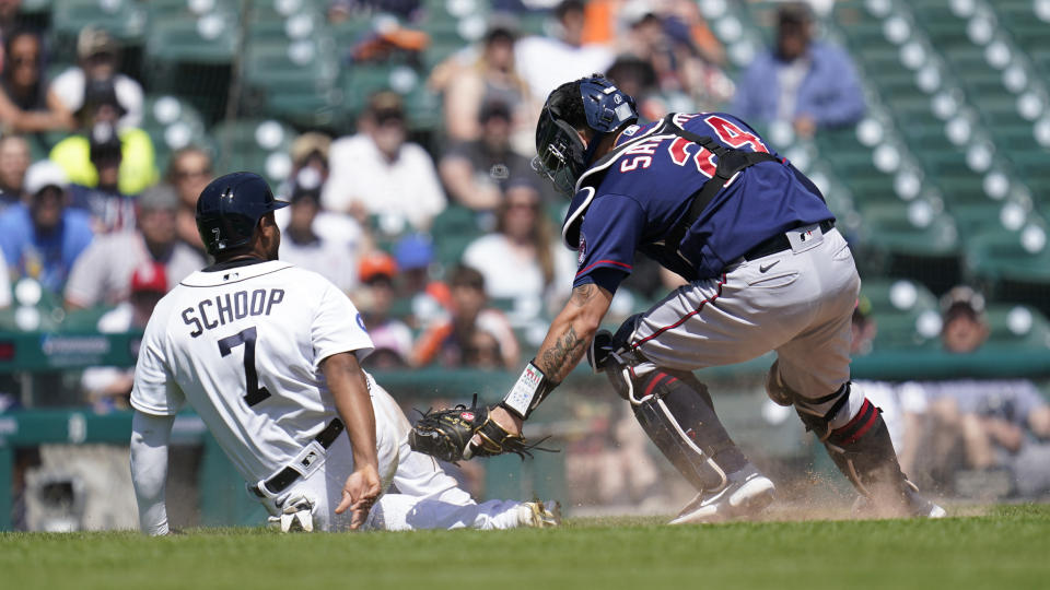 Detroit Tigers' Jonathan Schoop (7) avoids the tag of Minnesota Twins catcher Gary Sanchez (24 in the seventh inning of a baseball game in Detroit, Monday, May 30, 2022. Sanchez ended up making the tag for the out. (AP Photo/Paul Sancya)