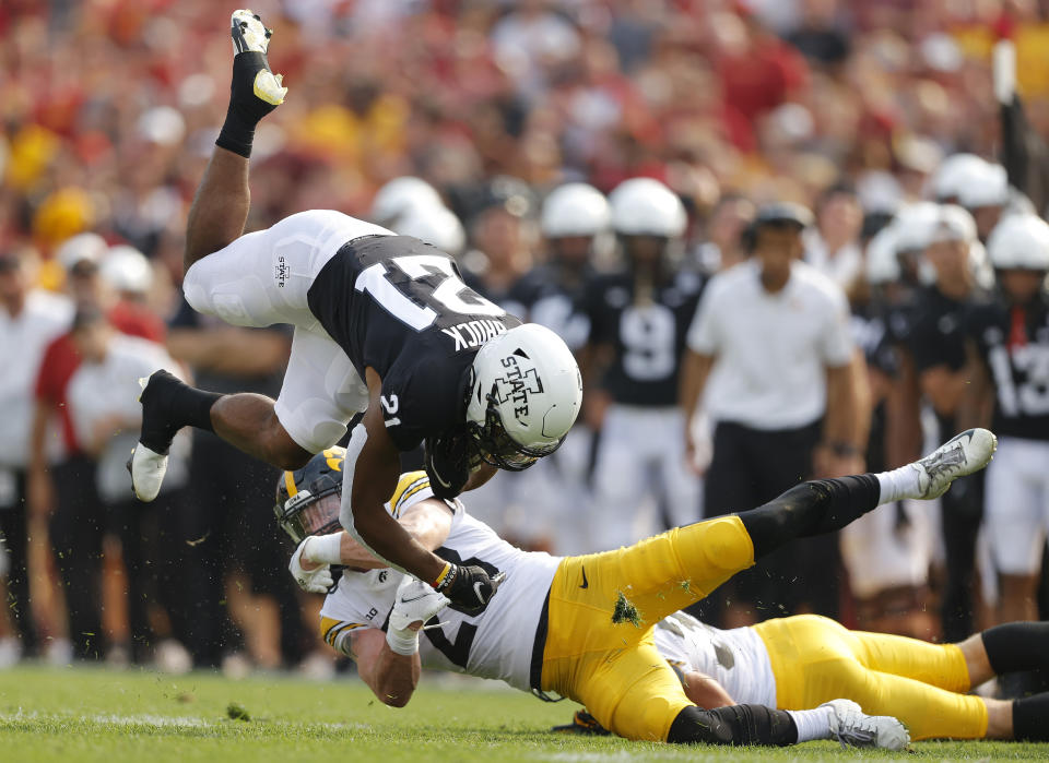 Iowa State running back Jirehl Brock (21) runs for a first down as he gets tripped up by Iowa defensive back Jack Koerner (28) during the first half of an NCAA college football game, Saturday, Sept. 11, 2021, in Ames, Iowa. (AP Photo/Matthew Putney)