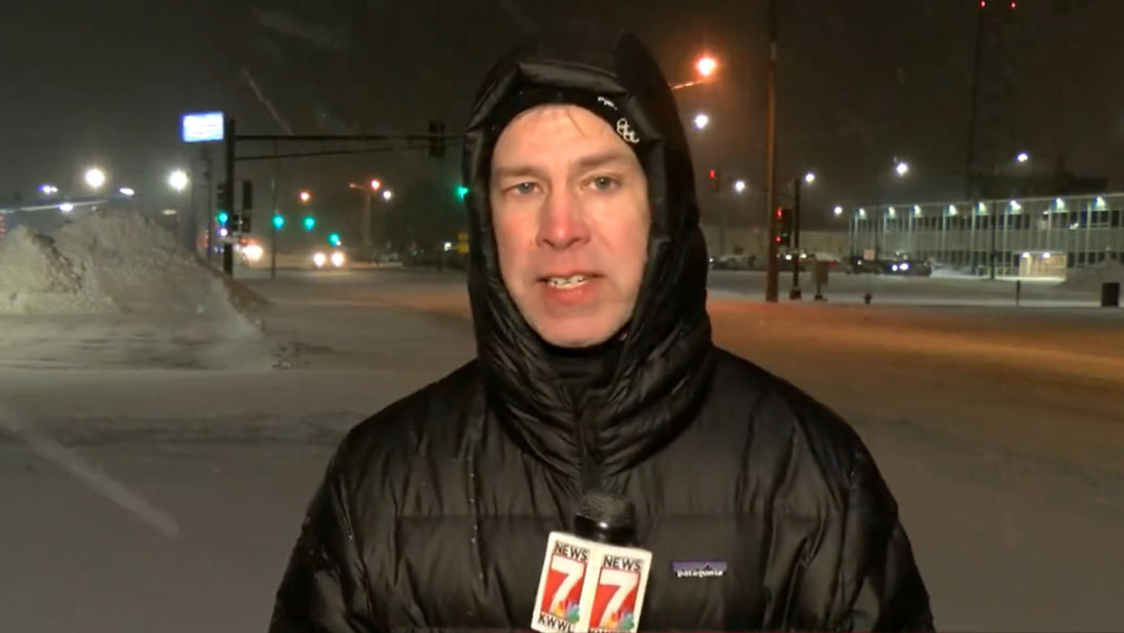 Sports reporter Mark Woodley was not pleased when he was asked to stand outside in the middle of the blizzards in Iowa. (KWWL-TV)