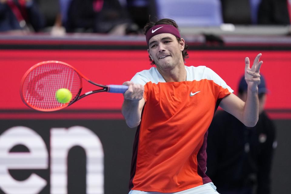 Taylor Fritz of the U.S. returns a shot against Denis Shapovalov of Canada during their semifinal match in the Japan Open tennis championships in Tokyo, Saturday, Oct. 8, 2022. (AP Photo/Hiro Komae)