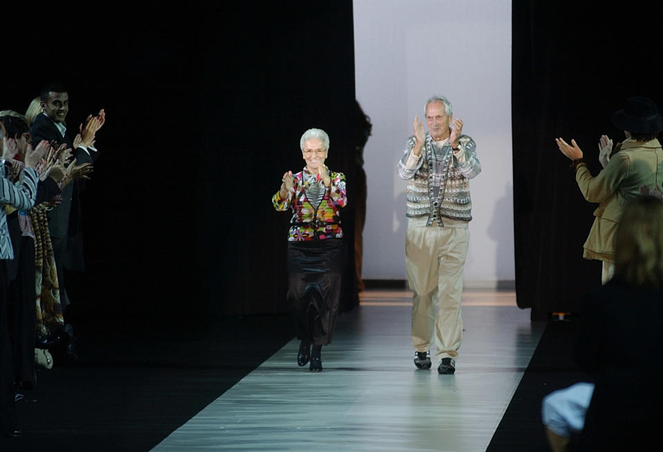 FILE - In this Oct. 2003 file photo Rosita, left, and Ottavio Missoni take the catwalk after presenting their Spring/Summer 2004 fashion collection, in Milan, Italy. Italian fashion company Missoni says its co-founder, Ottavio Missoni, has died in his home earlier on Thursday, May 9, 2013 in northern Italy. Missoni, who was 92, founded the iconic fashion brand of zigzagged-patterned knitwear along with his wife, Rosita, in 1953. The Missonis are a family fashion dynasty, with the couple’s children and their offspring involved in expanding the brand. (AP Photo/Antonio Calanni, File)