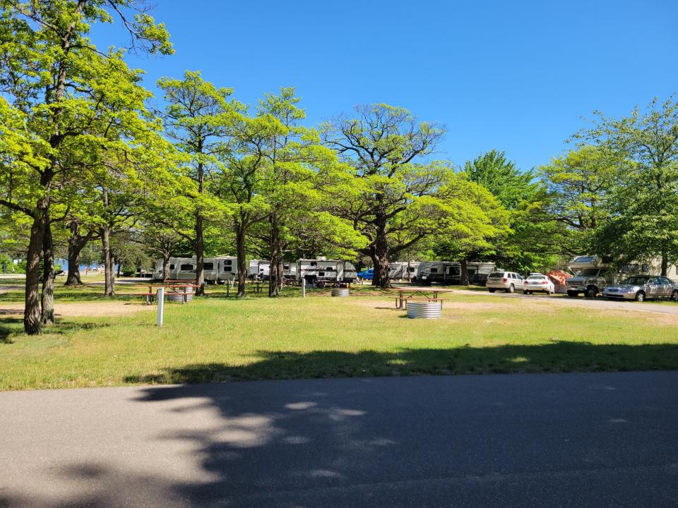 Lake Macatawa Campground has wooded and sunny campsites, with the majority of sites located on grass or gravel.