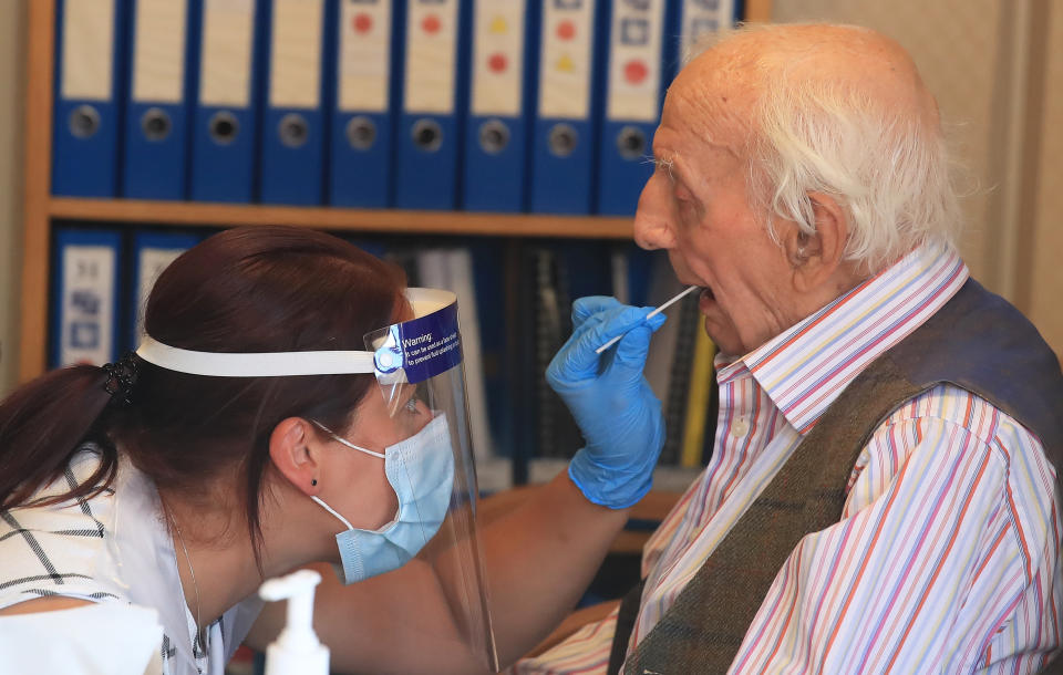 Assistant manager Claire Welford administers a coronavirus swab test on resident Harry Hall, 94, at the Eothen Homes care home in Whitley Bay, Tyneside, where all staff and residents are being tested for coronavirus. (Photo by Owen Humphreys/PA Images via Getty Images)