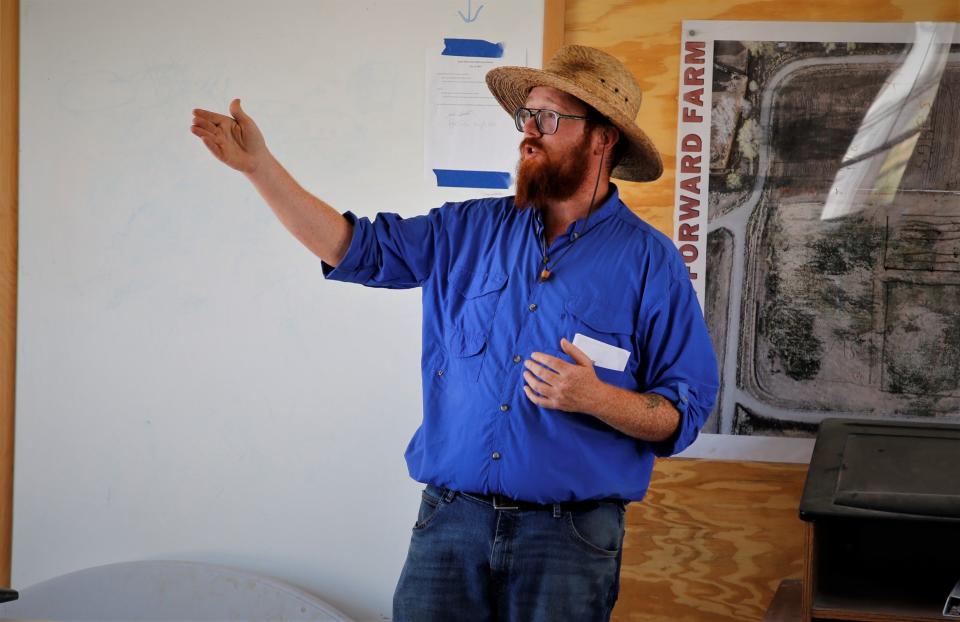 Growing Forward Farm coordinator discusses some of the farm's programs on Friday, July 21 in Aztec during a visit by participants in the Northwest New Mexico Local Food Summit.