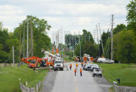 <p>Hydro Crews work to fix broken power poles and restore power in the Ottawa Valley municipality of Mississippi Mills, Ont., on Monday, May 23, 2022. A major storm hit parts of Ontario and Quebec on Saturday, May 21, 2022, leaving extensive damage to infrastructure. (Photo by Sean Kilpatrick/The Canadian Press)</p> 