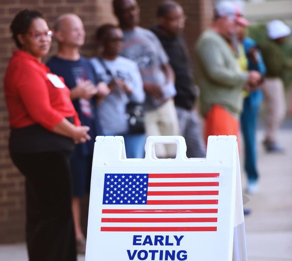 People wait in line to cast their ballots at the Orange County Supervisor of Elections Office on the first day of early voting for the 2022 midterm general election in Orlando.