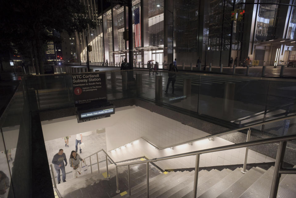 People walk up a flight of stairs in the World Trade Center complex from the newly-opened WTC Cortlandt subway station in New York on Saturday evening, Sept. 8, 2018. The old Cortlandt Street station on the subway system's No. 1 line was buried under the rubble of the World Trade Center's twin towers on Sept. 11, 2001. Construction of the new station was delayed until the rebuilding of the surrounding towers was well under way. (AP Photo/Patrick Sison)
