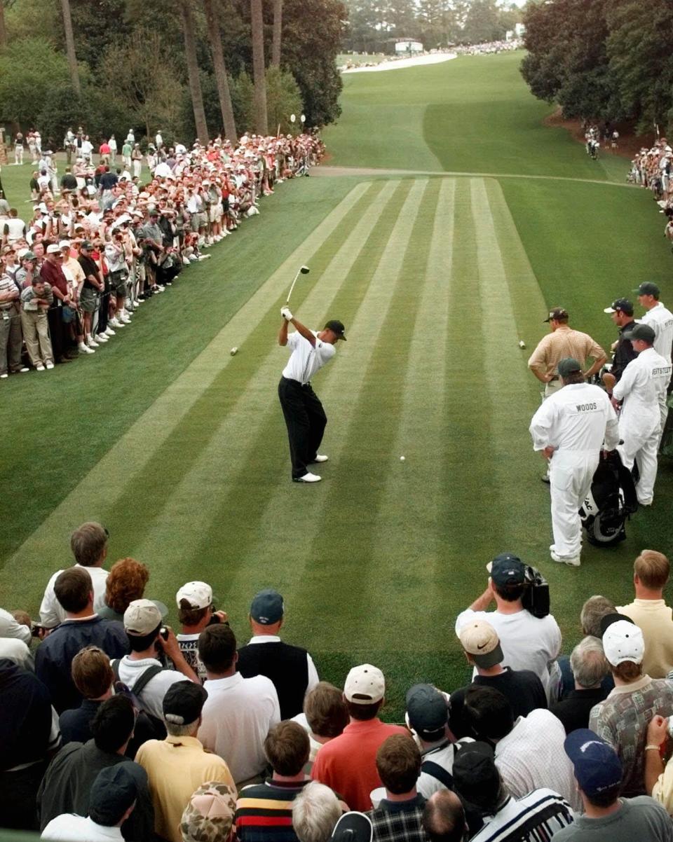 <p>Surrounded by the gallery, defending Masters champion Tiger Woods drives off of the 18th tee during the final day of practice for the 1998 Masters at the Augusta National Golf Club in Augusta, Ga., Wednesday, April 8, 1998. (AP Photo/Dave Martin) </p>