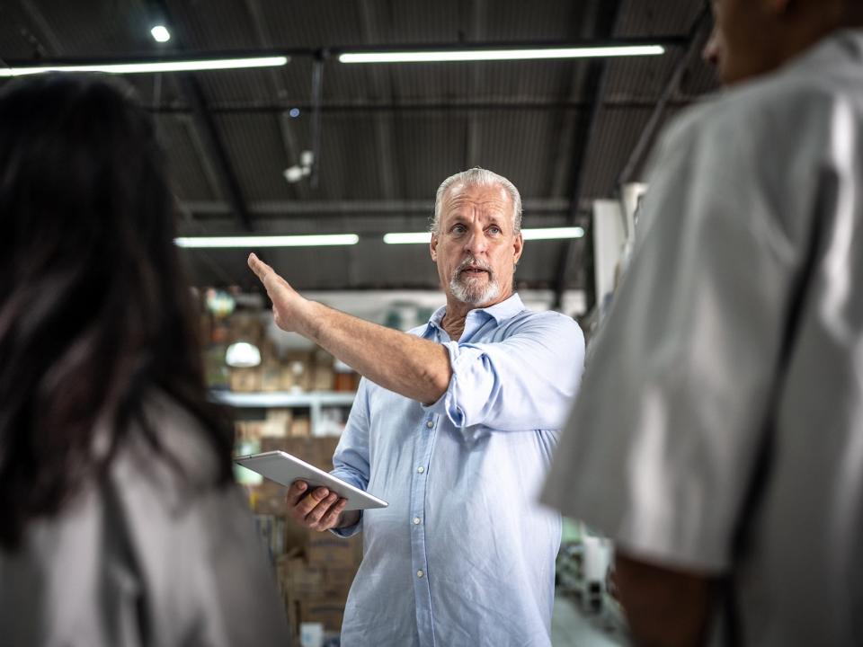 Manager, worker, or businessman talking to workers