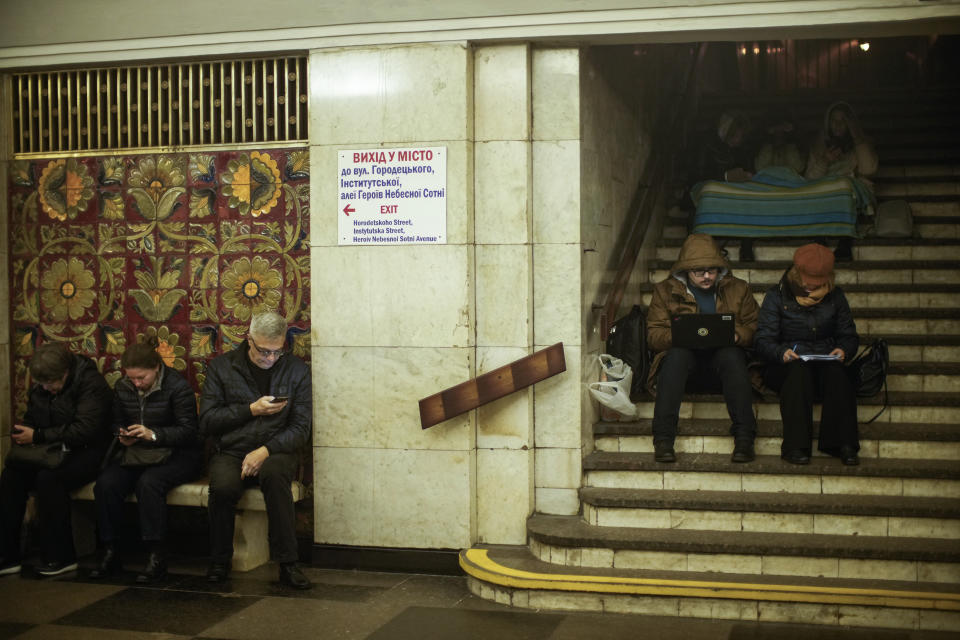 FILE - People sit in the subway, using it as a bomb shelter during an air raid alarm, in Kyiv, Ukraine, Thursday, Oct. 20, 2022. When air raid alarms sound in Ukraine, they also trigger a downloadable app that has been voiced by “Star Wars” actor Mark Hamill. With his gravely but also calming baritone, he urges people to take cover. He also tells them when the danger has passed, signing off with “May the Force be with you.” In an interview with The Associated Press, the actor said he’s admiring Ukraine's resilience from afar in California. (AP Photo/Francisco Seco, File)