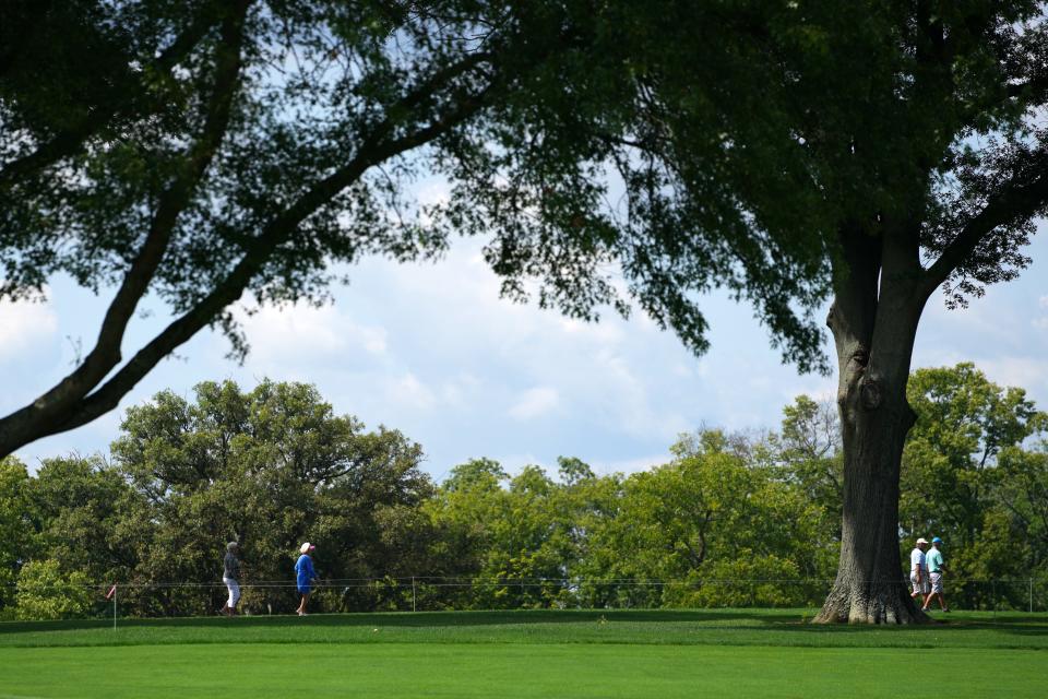 Spectators walk down the cart path along hole No. 1, Wednesday, Sept. 7, 2022, during a pro-am portion of the Kroger Queen City Championship golf tournament at Kenwood Country Club in Madeira, Ohio. 