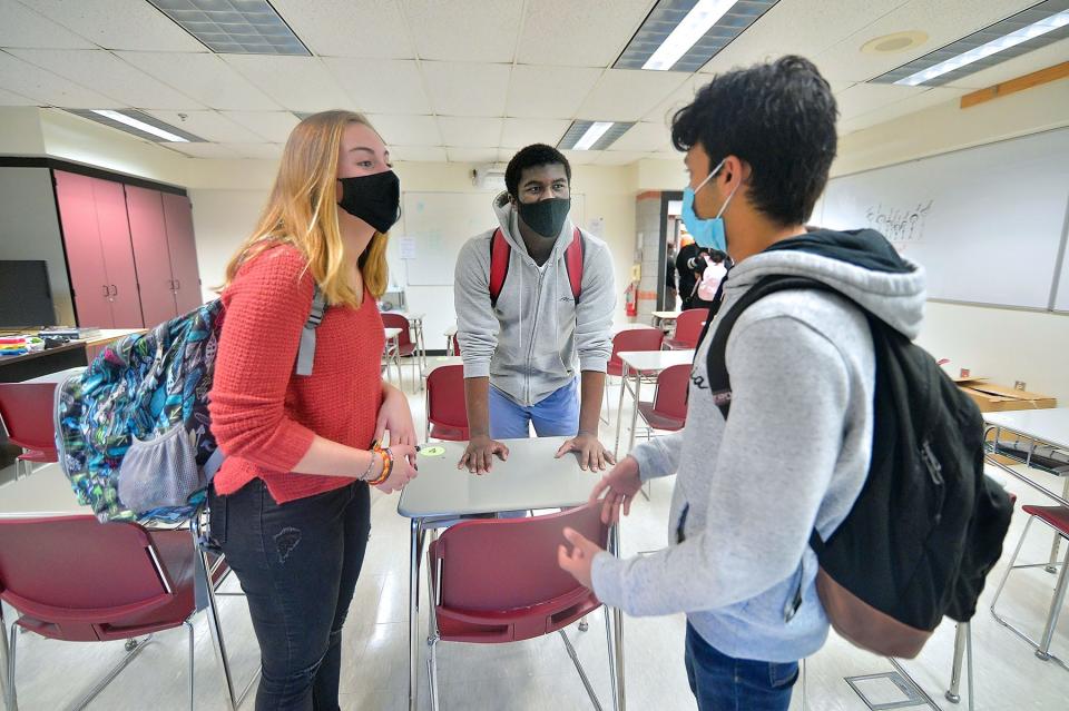 From left, North Hagerstown High School seniors Gabbie McCafferty, Bryan Boateng and Tanish Gupta wear face masks while attending class in late October.