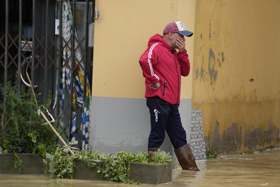 A man watches a flooded street in the village of Castel Bolognese, Italy, Wednesday, May 17, 2023. Exceptional rains Wednesday in a drought-struck region of northern Italy swelled rivers over their banks, killing at least eight people, forcing the evacuation of thousands and prompting officials to warn that Italy needs a national plan to combat climate change-induced flooding. (AP Photo/Luca Bruno)