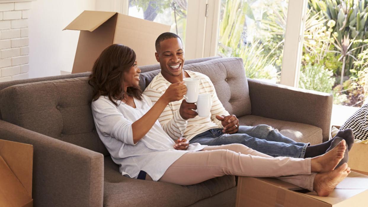 couple-on-sofa-taking-break-unpacking