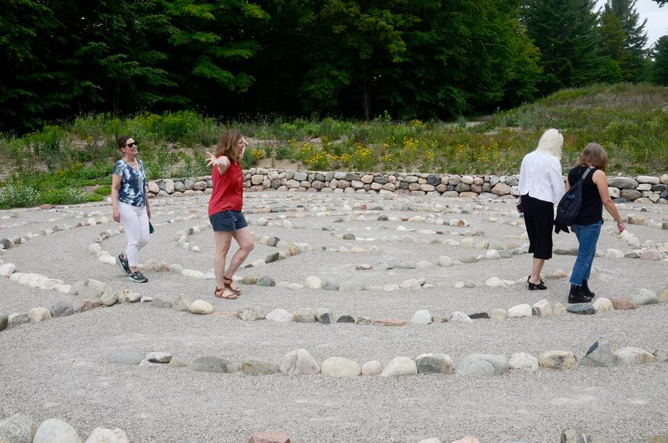 People walk in the Bluestem Meadow labyrinth on Wednesday, Aug. 2, 2023.