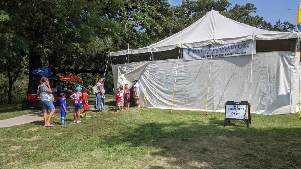 Children line up outside of the First Treasures tent at the Smoky Hill River Festival. First Treasures allows kids ages 4 to 13 to buy art from festival artists for $5 or less.