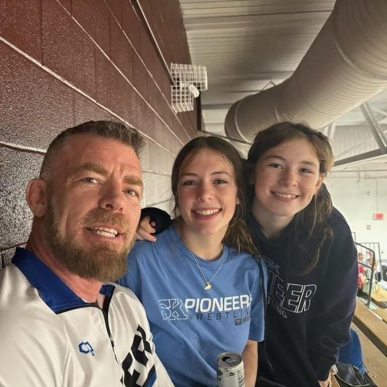 Simon Kenton wrestling coach Scott Smith (left) helped his oldest daughter Zoey (middle) win a KWCA state championship in 2021 and coached Allie (right) to an appearance in the 2024 girls wrestling state tournament.