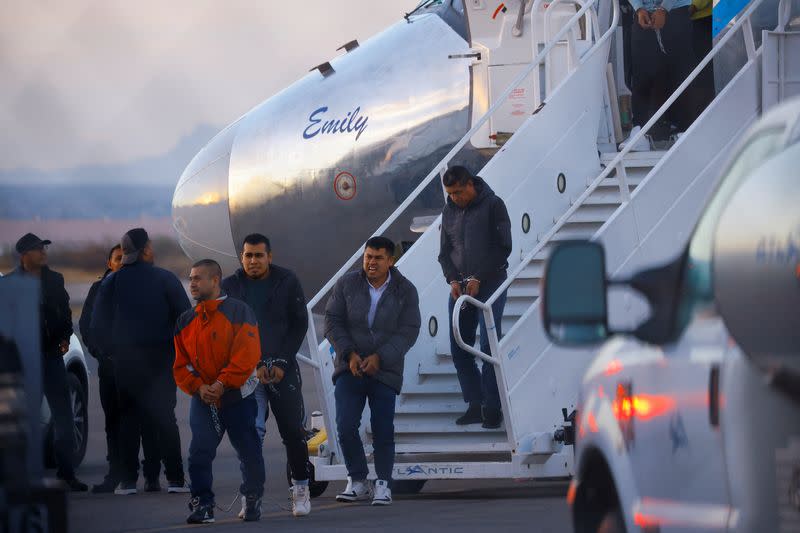 Migrants, transferred from Plattsburgh, New York to El Paso, Texas, disembark from a plane at the airport, in El Paso