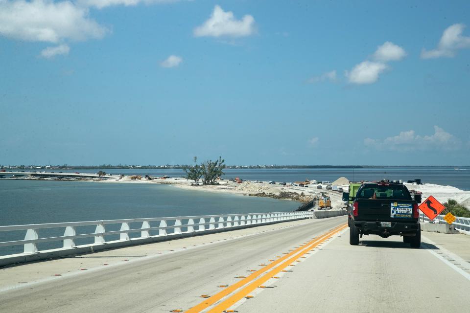 Contractors for the Florida Department of Transportation continue their work on the Sanibel Causeway on Thursday, Sept 7, 2023. Crews are paving new lanes as cranes so they can raise the existing roadway and backhoes are working in other areas to restore and improve the roadway.