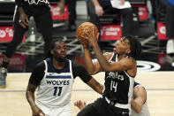 Los Angeles Clippers guard Terance Mann, right, shoots as Minnesota Timberwolves center Naz Reid defends during the first half of an NBA basketball game Sunday, April 18, 2021, in Los Angeles. (AP Photo/Mark J. Terrill)