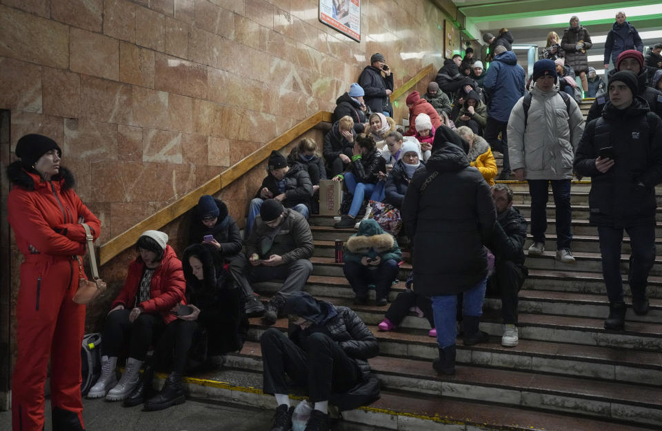 People rest in the subway station, being used as a bomb shelter during a rocket attack in Kyiv, Ukraine, Friday, Dec. 16, 2022. Ukrainian authorities reported explosions in at least three cities Friday, saying Russia has launched a major missile attack on energy facilities and infrastructure. Kyiv Mayor Vitali Klitschko reported explosions in at least four districts, urging residents to go to shelters. (AP Photo/Efrem Lukatsky)
