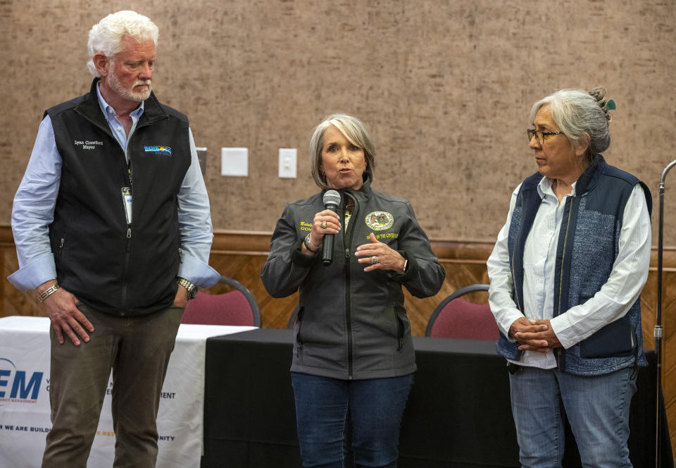 New Mexico Gov. Michelle Lujan Grisham, flanked by the mayor of Ruidoso Lynn Crawford, left, and the Mescalero Apache Tribe president Thora Walsh Padilla speaks during a media briefing in the mountain village of Ruidoso, N.M., Saturday, June 22, 2024. Recent rains and cooler weather are helping firefighters gain ground on two wildfires in southern New Mexico. (AP Photo/Andres Leighton)