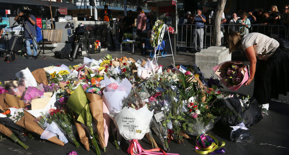 Flowers laid on the ground by members of the public outside Westfield in Bondi Junction. 