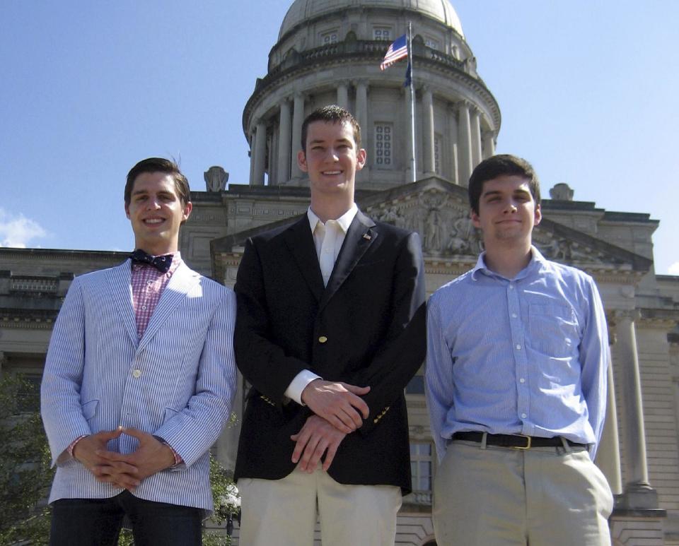 In this May 24, 2012, photo, John Ramsey, center, accompanied by Preston Bates left, and Doug Lusco, right, young Republicans involved in the Liberty For All political group, stand in front of the state Capitol in Frankfort, Ky. John Ramsey stands out in a new campaign finance world order filled with big names like Republican casino mogul Sheldon Adelson and Democratic Hollywood producer Jeffrey Katzenberg. The little-known senior at Stephen F. Austin University.is the founder of a team of college-aged Republicans that liberals have dubbed the “Brat PAC,” which helped propel one congressional candidate to victory and intends to get involved in other House races. And he’s just the latest wealthy individual to try to influence federal elections in the wake of a series of federal court decisions that deregulated the campaign finance system and dramatically changed the country’s political landscape. (AP Photo/Roger Alford)