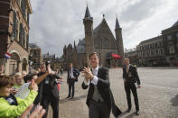 Dutch Prime Minister Mark Rutte greets children as he arrives at the Knight's Hall, rear, in The Hague, Netherlands, Tuesday, Sept. 17, 2019, for a ceremony marking the opening of the parliamentary year with a speech by King Willem-Alexander outlining the government's budget plans for the year ahead. (AP Photo/Peter Dejong)