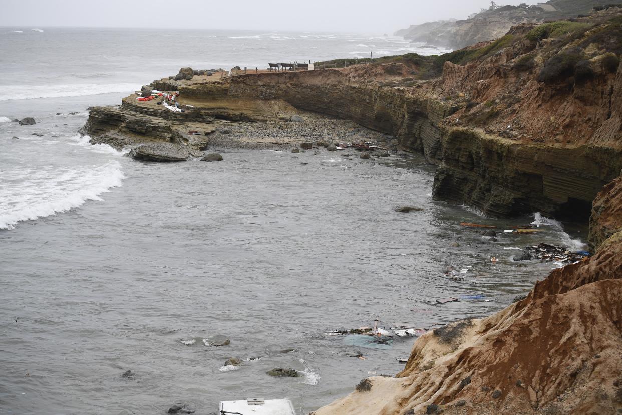 Wreckage and debris from a capsized boat washes ashore at Cabrillo National Monument near where a boat capsized just off the San Diego coast Sunday, May 2. 