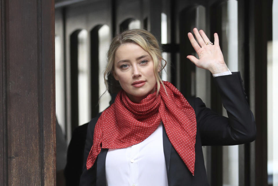 Actress Amber Heard arrives at the High Court for a hearing in Johnny Depp's libel case, in London, Friday, July 24, 2020. Depp is suing News Group Newspapers, publisher of The Sun, and the paper's executive editor, Dan Wootton, over an April 2018 article that called him a "wife-beater." The Sun's defense relies on a total of 14 allegations by Heard of Depp's violence. He strongly denies all of them. (Aaron Chown/PA via AP)