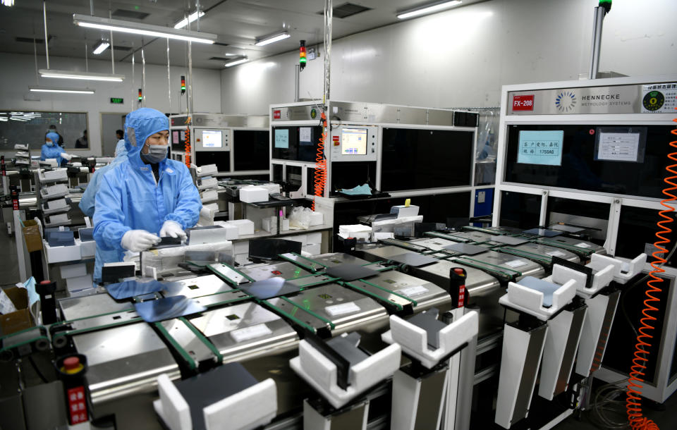 LIANYUNGANG, CHINA - JANUARY 13: An employee works on a silicon wafer inspection system at a semiconductor manufacturing enterprise on January 13, 2021 in Lianyungang, Jiangsu Province of China. (Photo by Zhang Kaihu/VCG via Getty Images)