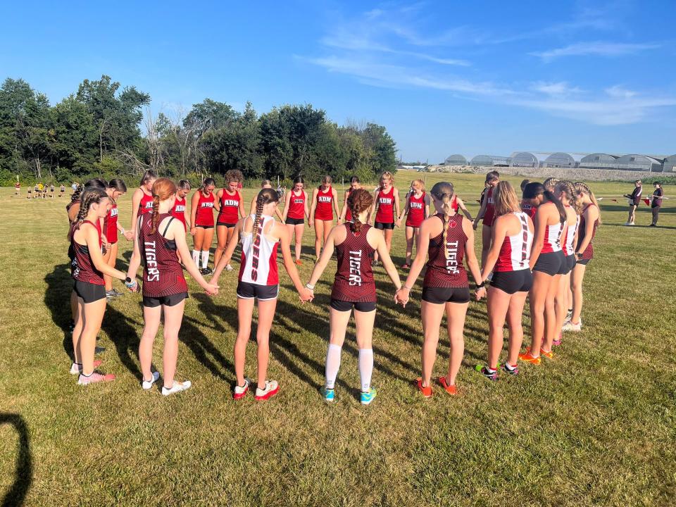 Members of the ADM girls cross country team get set before a meet on Saturday, Sept. 2, 2023, in Pella.