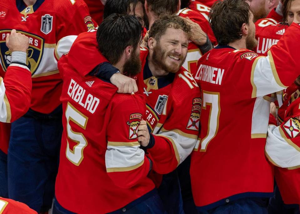 Florida Panthers players Tkachuk (19) and Aaron Ekblad (5) celebrate after winning Stanley Cup.