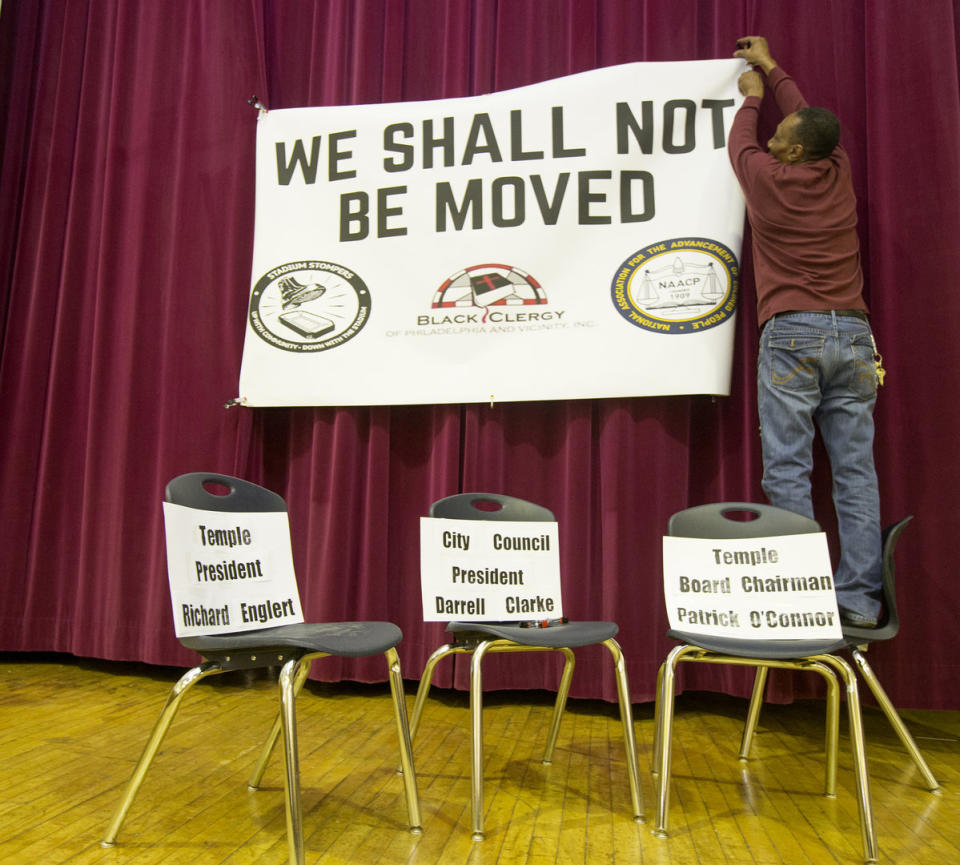 Neighbors opposing the stadium carried “We Shall Not Be Moved” signs as Temple (briefly) made its case for the $130 million plan. (Via Philly.com)