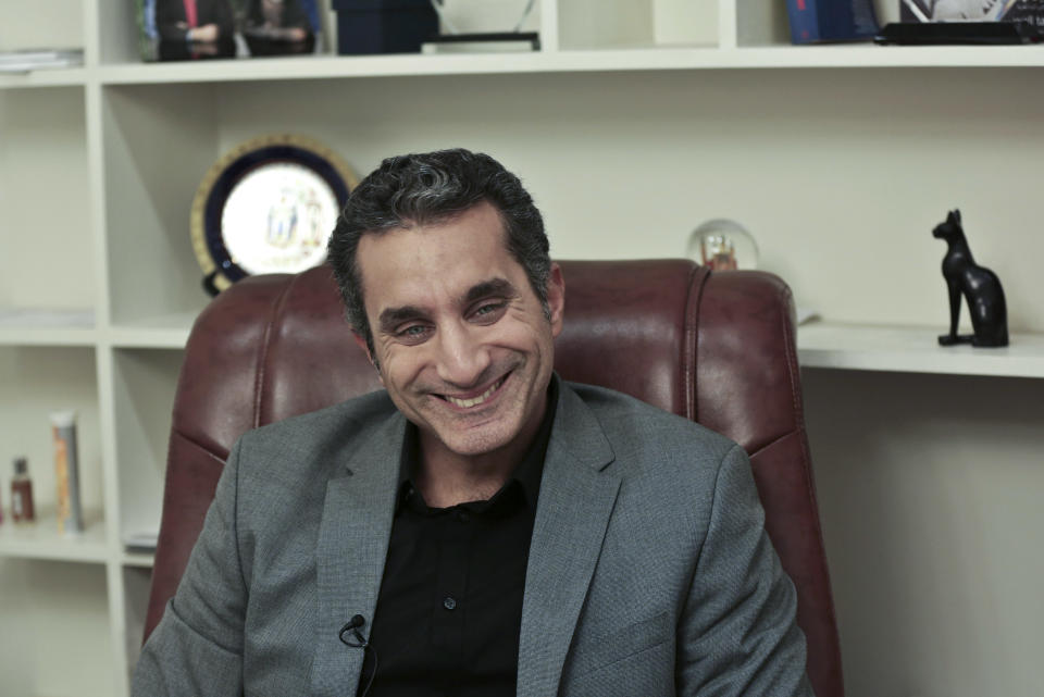 Egyptian satirist Bassem Youssef laughs during an interview with The Associated Press at his studio in downtown Cairo, Egypt, Wednesday, Jan. 8, 2014. Youssef, often compared to U.S. comedian Jon Stewart, says his team will bring back its popular television show poking fun at politics in a country still beset by turmoil following a July military coup. However, he acknowledged the challenges facing him and others in Egypt now in an interview with The Associated Press. (AP Photo/Nariman El-Mofty)