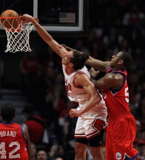 Joakim Noah of the Chicago Bulls dunks the ball over Elton Brand (L) and Lavoy Allen (R) of the Philadelphia 76ers in Game One of the Eastern Conference quarter-finals during the 2012 NBA Playoffs at the United Center in Chicago, Illinois. Chicago won 103-91