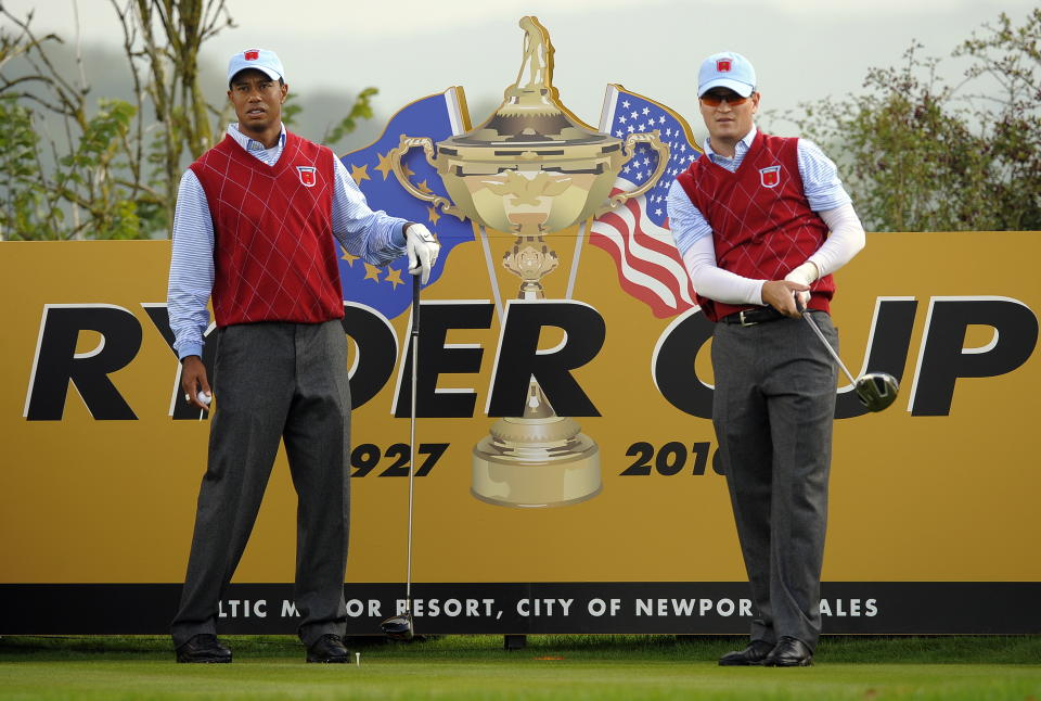 U.S. Ryder Cup player Tiger Woods (L) watches as teammate Zach Johnson plays his tee shot from the fourth during a practice session at Celtic Manor golf course in Newport, Wales on September 28, 2010. (Photo: Timothy A. Clary/AFP via Getty Images)