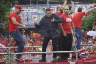 Hugo Chavez dances after delivering a speech during his closing campaign rally in Caracas, Venezuela, 2012. He revealed in June 2011 he had a tumour. He received medical care in Cuba and said he had recovered in July 2012, ahead of the elections but returned to the island shortly after for further treatment. As a result of his illness he missed his inauguration as President in January and urged Venezuelans to vote for vice-president Nicolás Maduro as his successor (PA)