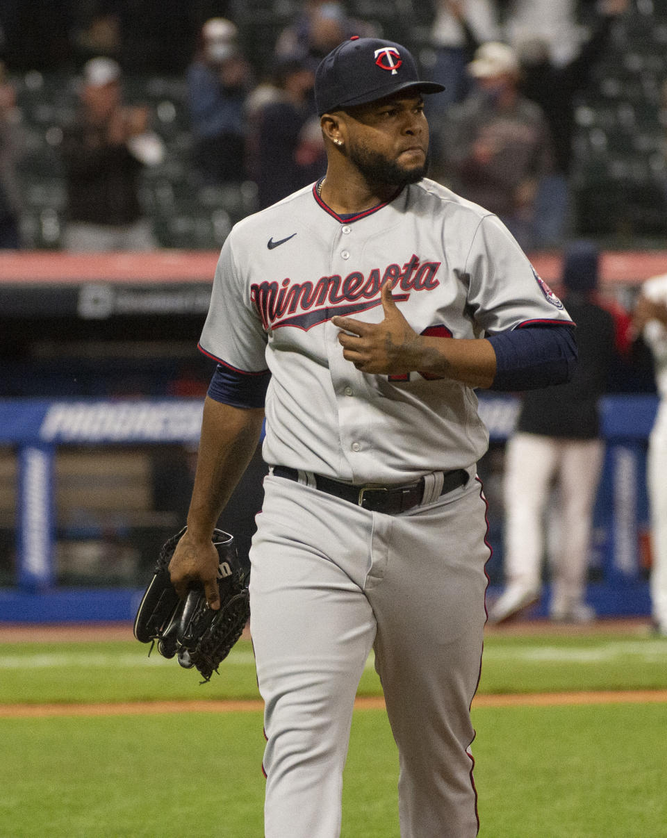Minnesota Twins relief pitcher Alex Colome walks to the dugout after giving up a two-run home run to Cleveland Indians' Jordan Luplow during the tenth inning of a baseball game in Cleveland, Monday, April 26, 2021. (AP Photo/Phil Long)