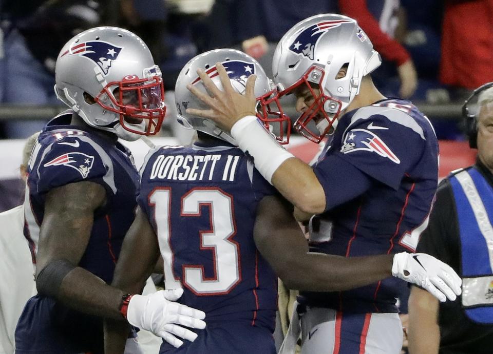 New England Patriots quarterback Tom Brady, right, celebrates his touchdown pass to Phillip Dorsett, center, in the second half of an NFL football game against the Pittsburgh Steelers, Sunday, Sept. 8, 2019, in Foxborough, Mass. (AP Photo/Steven Senne)
