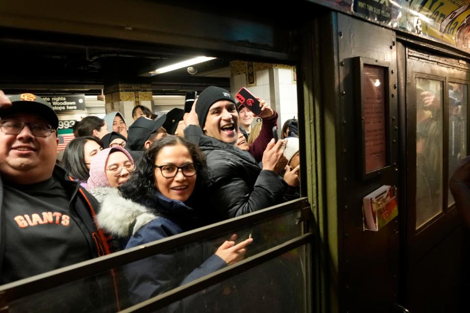 Yankee fans are excited to enter a vintage subway car on their way to the stadium for Yankees Opening Day.  The subway car, built just after WWI, is called a  Low-V or "low voltage" train. Thursday, March 30, 2023