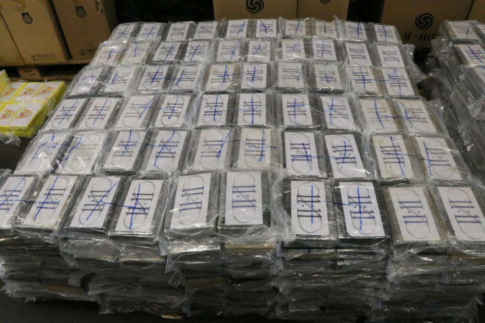 In this file handout photo from July, 2019, German customs authorities display 4.5 tons (nearly 5 U.S. tons) of cocaine seized from containers shipped to Hamburg, Germany, from Uruguay, a haul with an estimated street value of nearly 1 billion euros ($1.1 billion). The shipment was green lighted in Uruguay without inspection despite its unusual nature: It had four containers of soybeans, a much smaller quantity than a normal shipment would contain. (German Custom via AP, File)