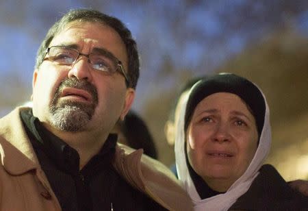 Namee Barakat and his wife Layla Barakat, parents of shooting victim Deah Shaddy Barakat, react as a video is played during a vigil on the campus of the University of North Carolina in Chapel Hill, North Carolina February 11, 2015. REUTERS/Chris Keane