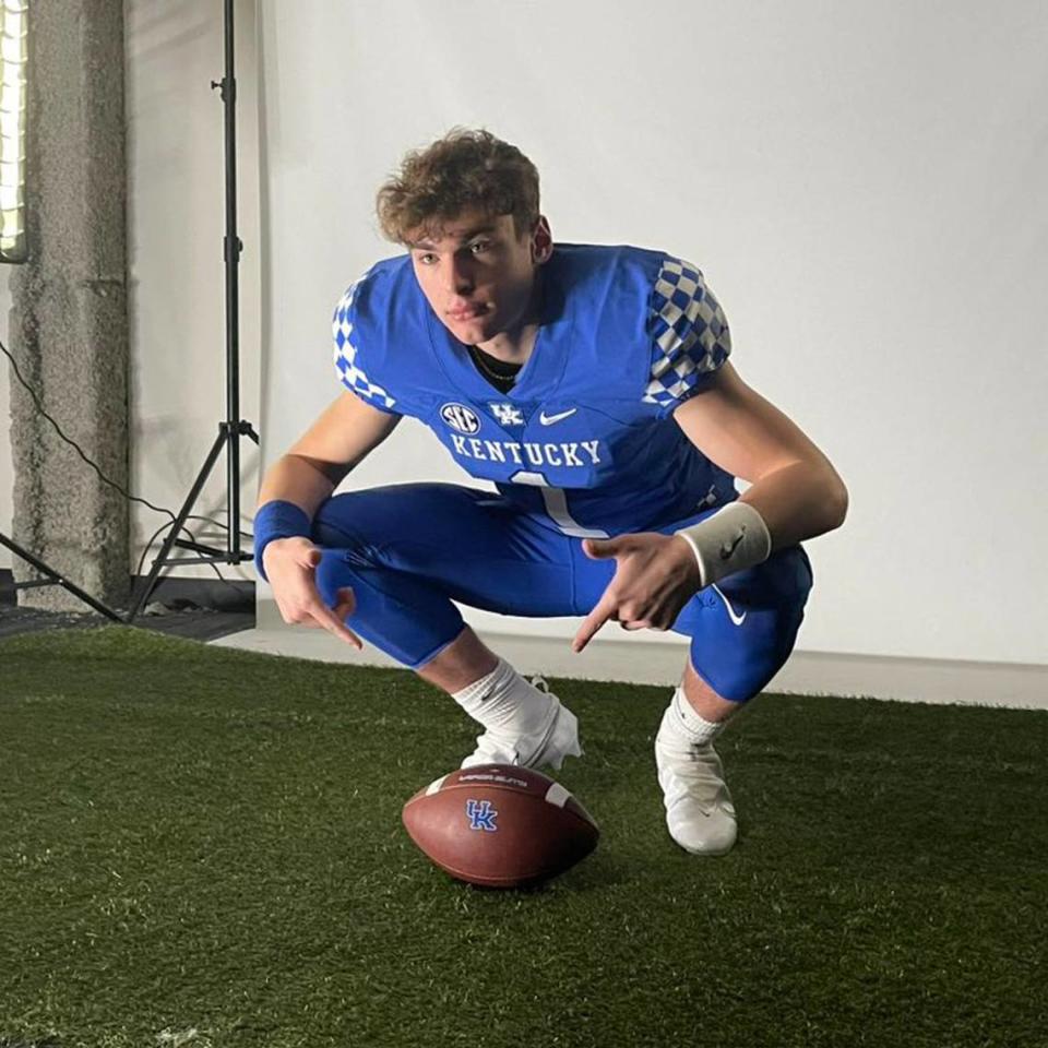 Stone Saunders, a class of 2025 quarterback prospect, poses in a Kentucky uniform during a recruiting visit.