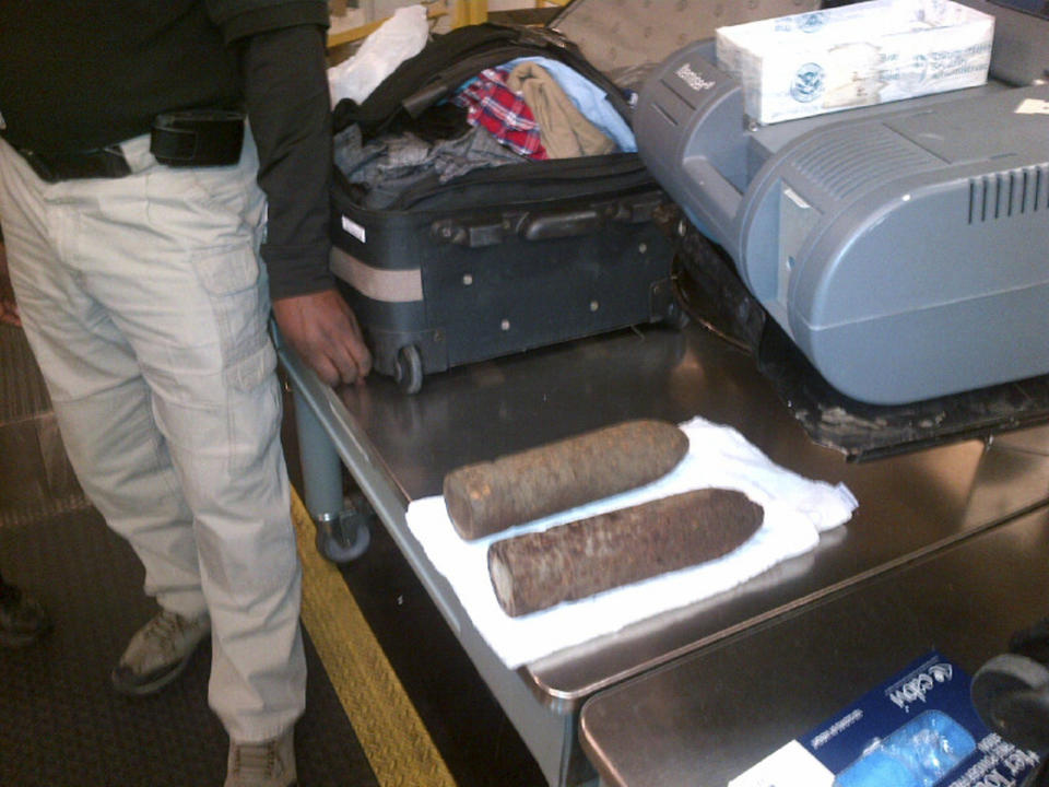 This Monday, April 7, 2014 photo provided by the Transportation Security Administration (TSA) shows two World War I artillery shells discovered by baggage screeners in checked luggage that arrived on a flight from London at Chicago's O'Hare International Airport. The TSA says the bags belonged to a 16-year-old and a 17-year-old who were returning from a school field trip to Europe. A bomb disposal crew determined the shells were inert and no one was ever in danger. The teens were questioned then allowed to travel onward. They weren't charged. (AP Photo/Transportation Security Administration)